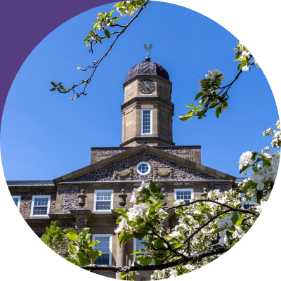 Inset in circular image of trees in foreground and university building tower in background against light-blue sky